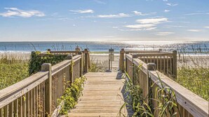 A wooden boardwalk leading to a beach with a clear view of the ocean. - Oceanfront Condo+Pools, Lazy River, Beach Access (Myrtle Beach)