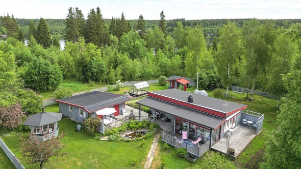 A large house with multiple sections, including a main building and a separate garage.