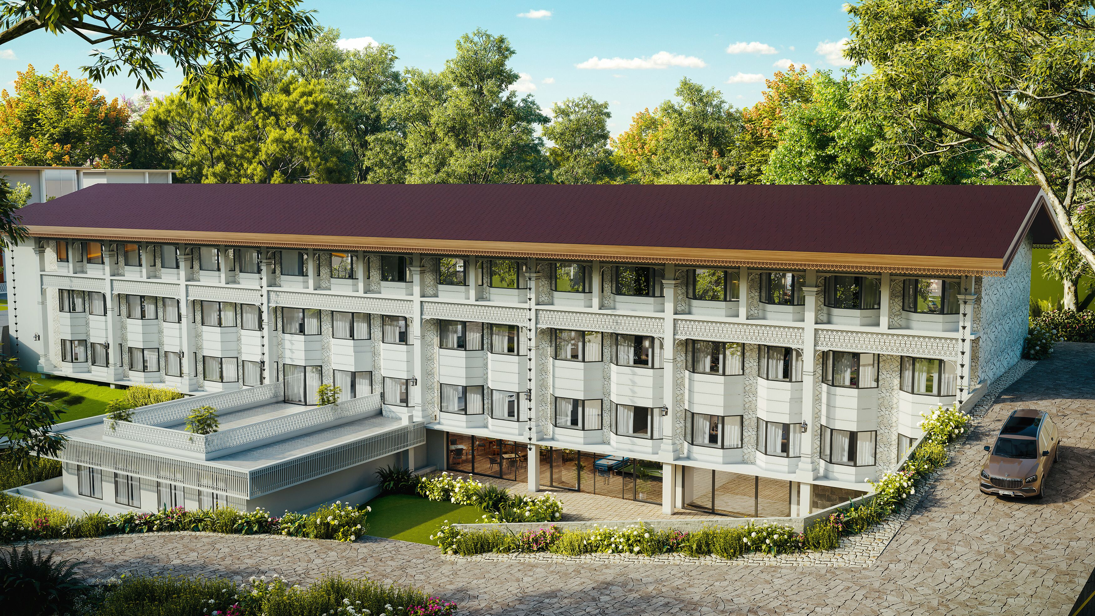 Un hotel de varios pisos con techo plano, ventanas amplias y un patio central con mobiliario.