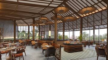 Un comedor interior amplio con techos altos, ventanas grandes y una isla central con comida.