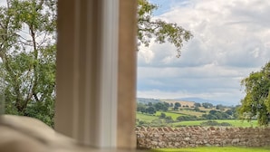 A stone wall with a view of a green landscape and hills in the distance. - High House, Southwaite -  a cottage that sleeps 10 guests  in 5 bedrooms (Southwaite)