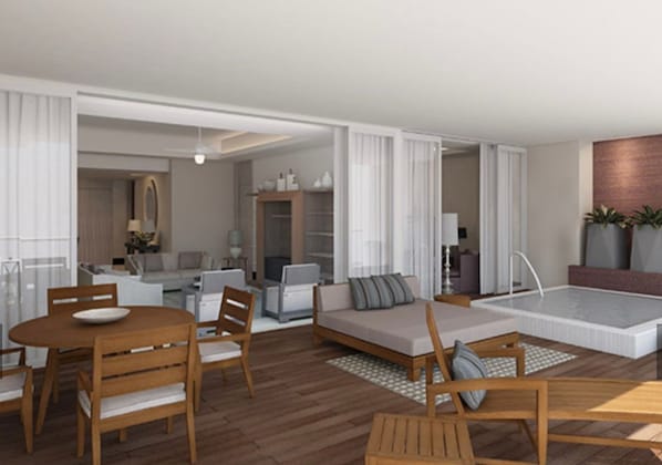 Amplia sala de estar con mesa de comedor de madera, sofá y una pequeña piscina.