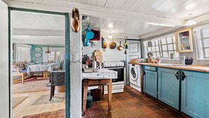 A rustic kitchen with a washing machine, stove, and various kitchen utensils. - 4 bedroom gorgeous home in Fanø (Fanø)