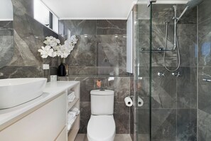 Shower, hair dryer, towels, toilet paper