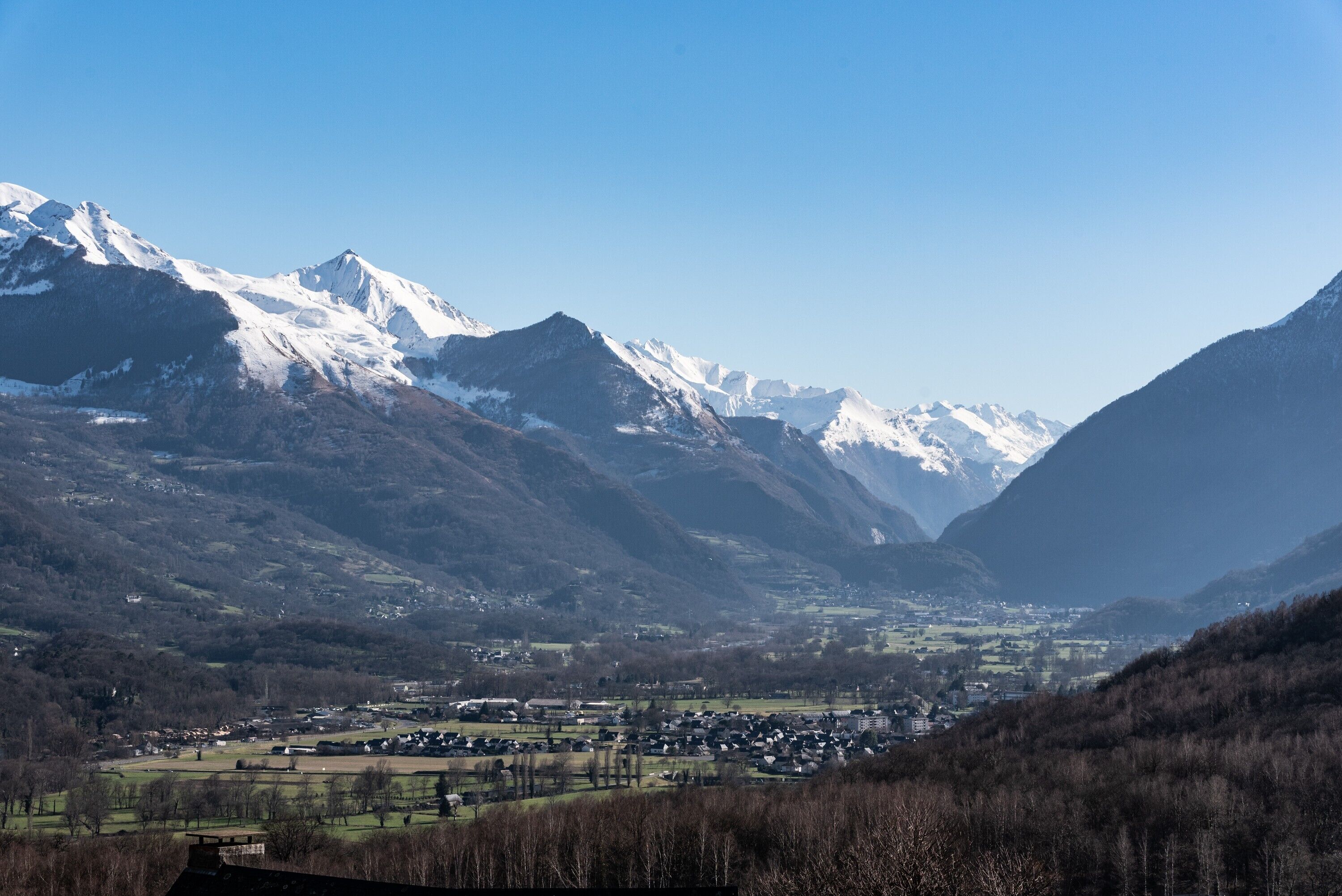 A mountainous landscape with a valley town.