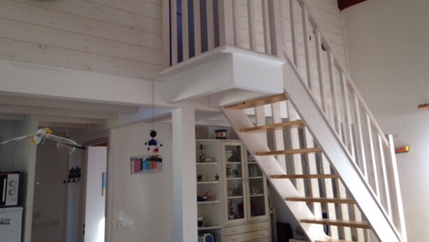 A room with a staircase, a white cabinet with glass doors, and a life preserver on the wall. - Tranquil Escape: House with Private Garden, 150m from the Forest and 20min to the Beach (Saint-Trojan-les-Bains)