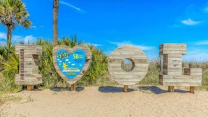 Wooden letters spelling 'TOLEDO' on a beach with a heart-shaped sign in the center. - Ocean Lakes T36 (Myrtle Beach)