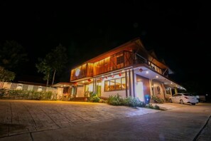 A two-story building with a flat roof, large windows, and a paved entrance area. - Ratana boutique resort (Klaeng)
