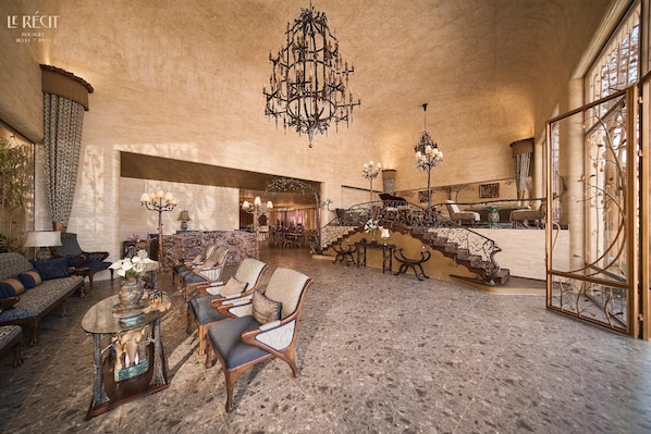 A spacious lobby with a grand staircase, elegant furniture, and ornate chandeliers. - Le Recit Boutique Hotel De Dalat (Xuan Huong - Da Lat)