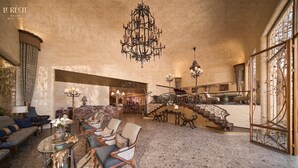 A spacious lobby with a grand staircase, elegant furniture, and ornate chandeliers. - Le Recit Boutique Hotel De Dalat (Xuan Huong - Da Lat)