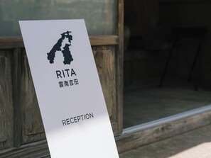 A reception sign with a map silhouette and the name 'RITA' and 'RECEPTION' written on it.