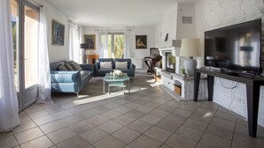 A spacious living room with a fireplace, a television, and a piano. - Villa Bellevue by Interhome (Saint Paul de Vence)