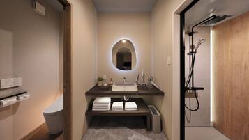 A modern bathroom with a vanity, sink, mirror, and shower.