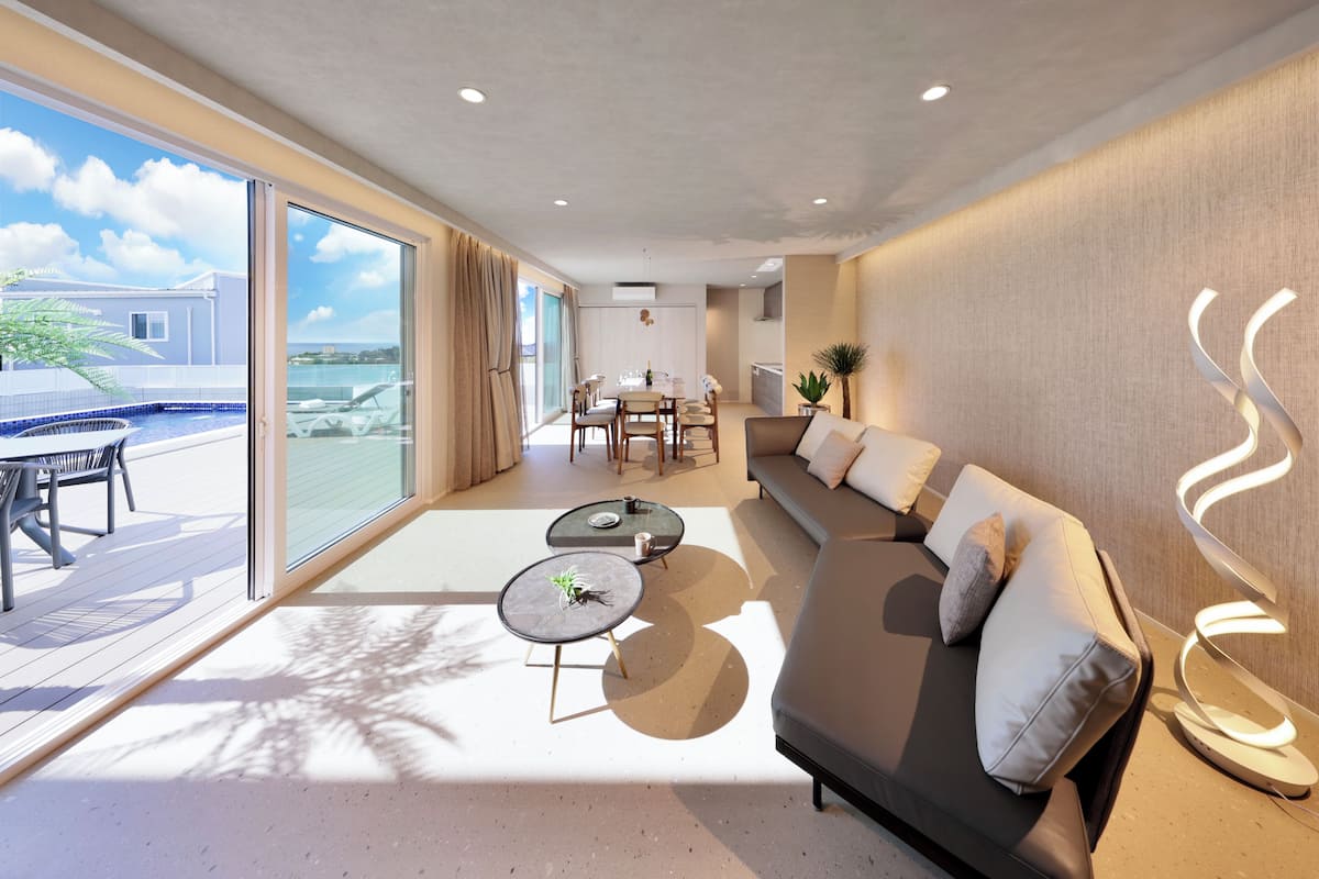 A modern living room with a sofa, coffee table, and dining area.