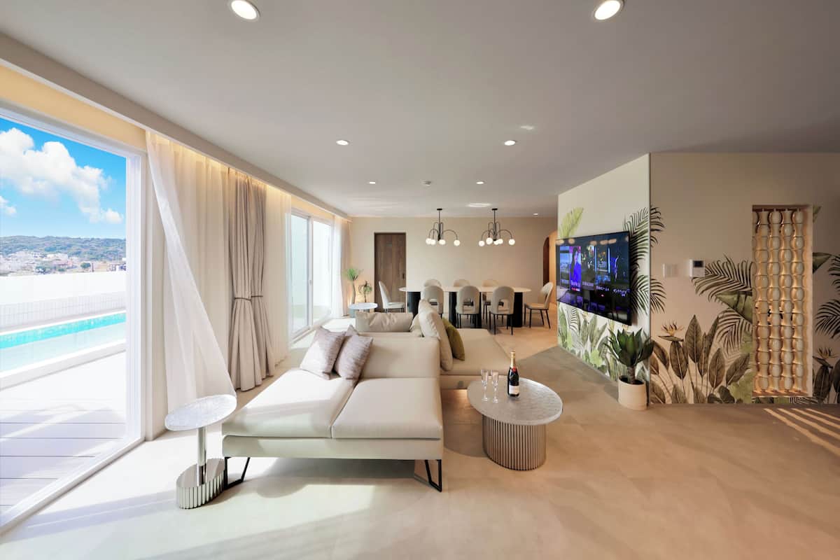 A modern living room with a sofa, coffee table, and TV.