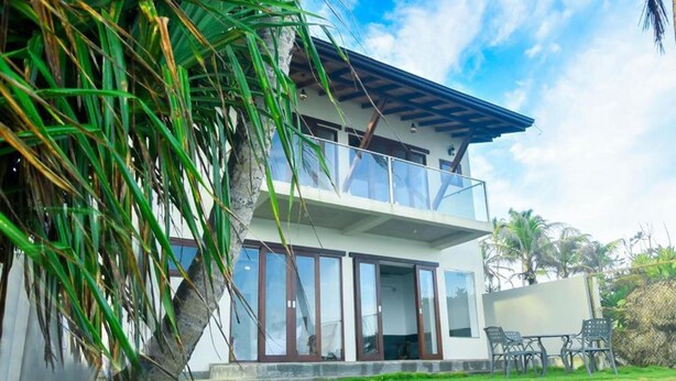 A two-story building with large windows and a balcony. - Surfside Serenity Ahangama (Ahangama)