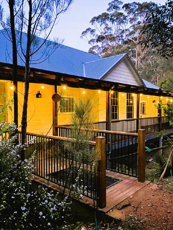 A two-story building with a balcony and a wooden deck.