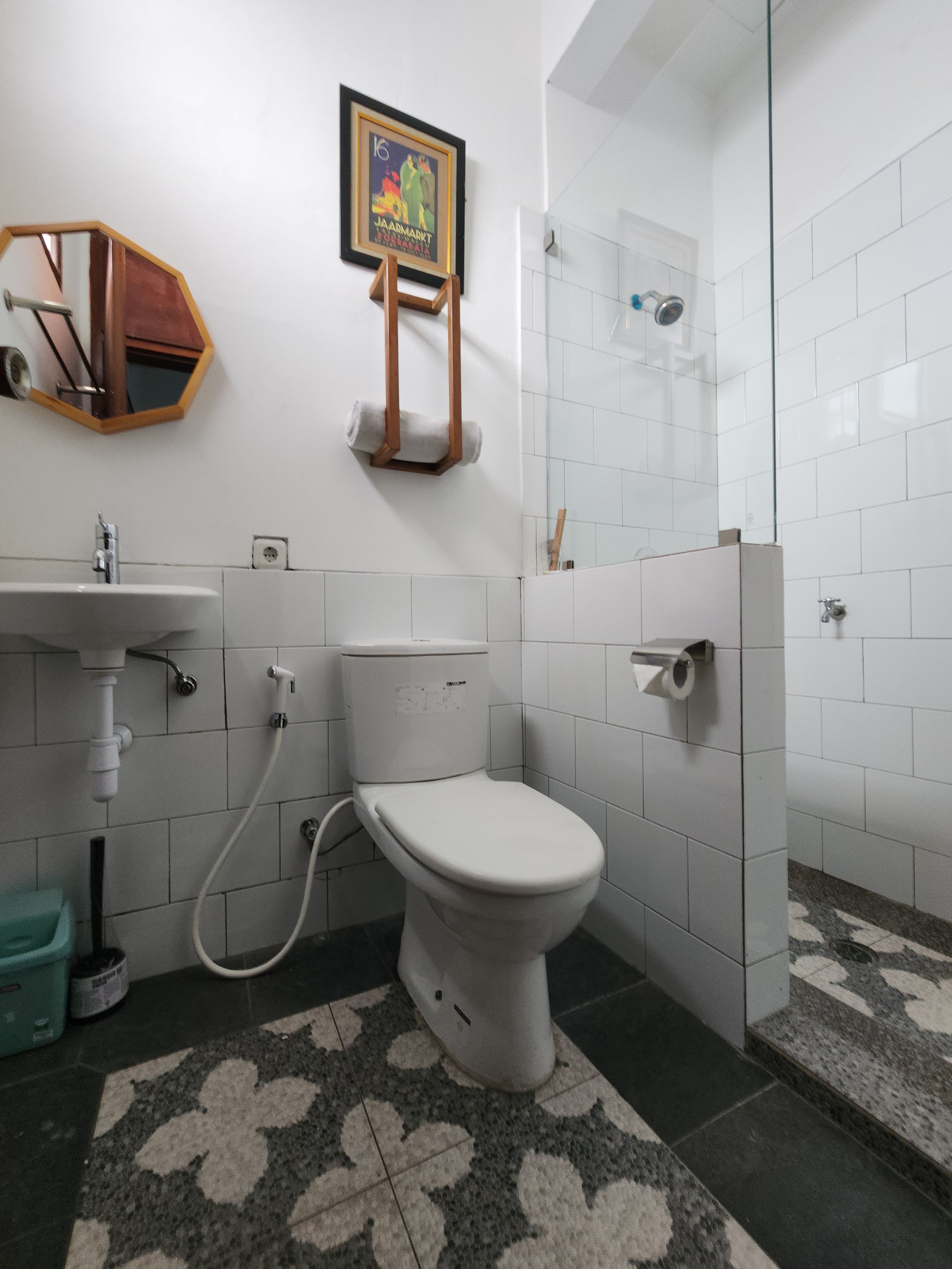A bathroom with a toilet, sink, and shower.