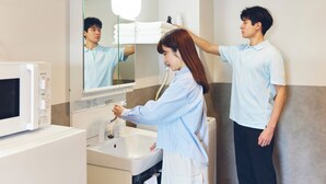 A hotel bathroom with a sink, mirror, and a microwave. - MONTANA WING YEBISU (Osaka)