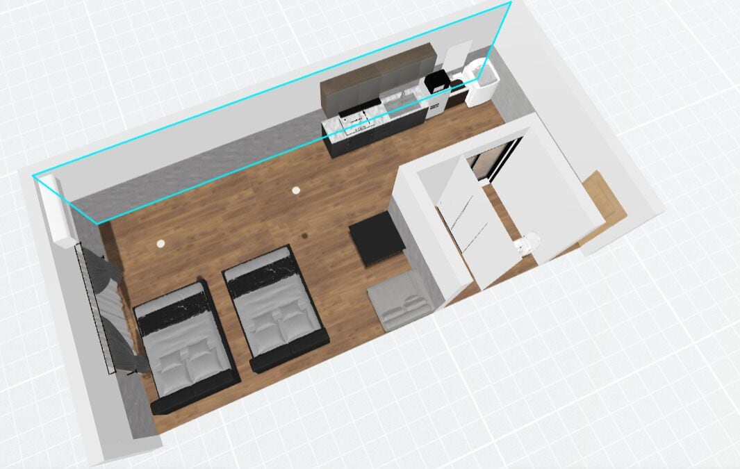 A 3D model of a hotel room with a wooden floor, a bed, a desk, a chair, a wardrobe, and a bathroom.