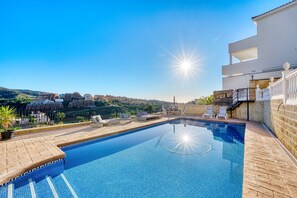 A rooftop swimming pool with lounge chairs and a view of the cityscape. - 3077 Luxury Villa with Pool and Views in Elviria, Marbella (Marbella)