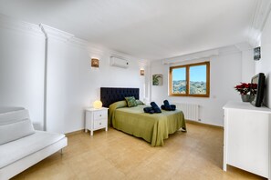 A bedroom with a bed, bedside table, and a view of the outdoors. - 3077 Luxury Villa with Pool and Views in Elviria, Marbella (Marbella)