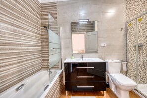 A modern bathroom with a bathtub, a vanity with a mirror, and a toilet. - 3077 Luxury Villa with Pool and Views in Elviria, Marbella (Marbella)