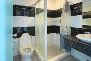 A bathroom with a toilet, shower, and sink. - Here Innstead Boracay powered by Cocotel (Boracay Island)
