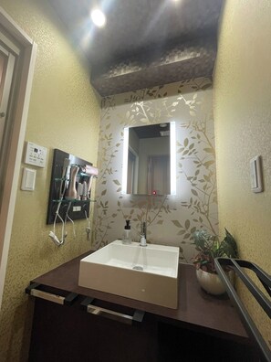A bathroom with a white sink, a mirror, and a hairdryer mounted on the wall. - No 201 2F / Ota-ku Tokyo (Ota-ku)