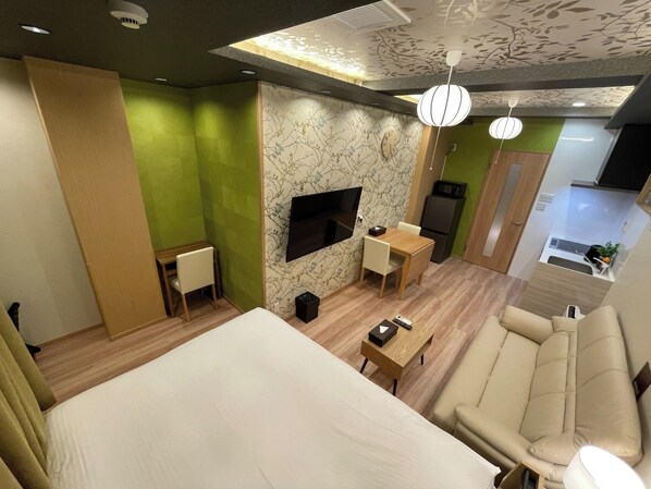 A modern hotel room with a large bed, a sofa, a small table, a TV, and a kitchenette. - No 201 2F / Ota-ku Tokyo (Ota-ku)