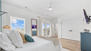 A bedroom with a bed, a ceiling fan, a TV, and a wardrobe. - Luxury 5BR Escape | Pool & Hot Tub | Sleeps 16 (Surfside Beach)