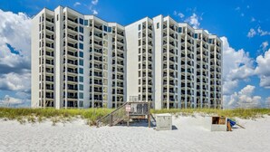A multi-story hotel with balconies, a beach access area, and a small structure on the sand. - Breathtaking Views - 7th Floor Beachfront Condo - Tennis, Basketball, Shuffleboard, Elevator, Pool (Navarre)