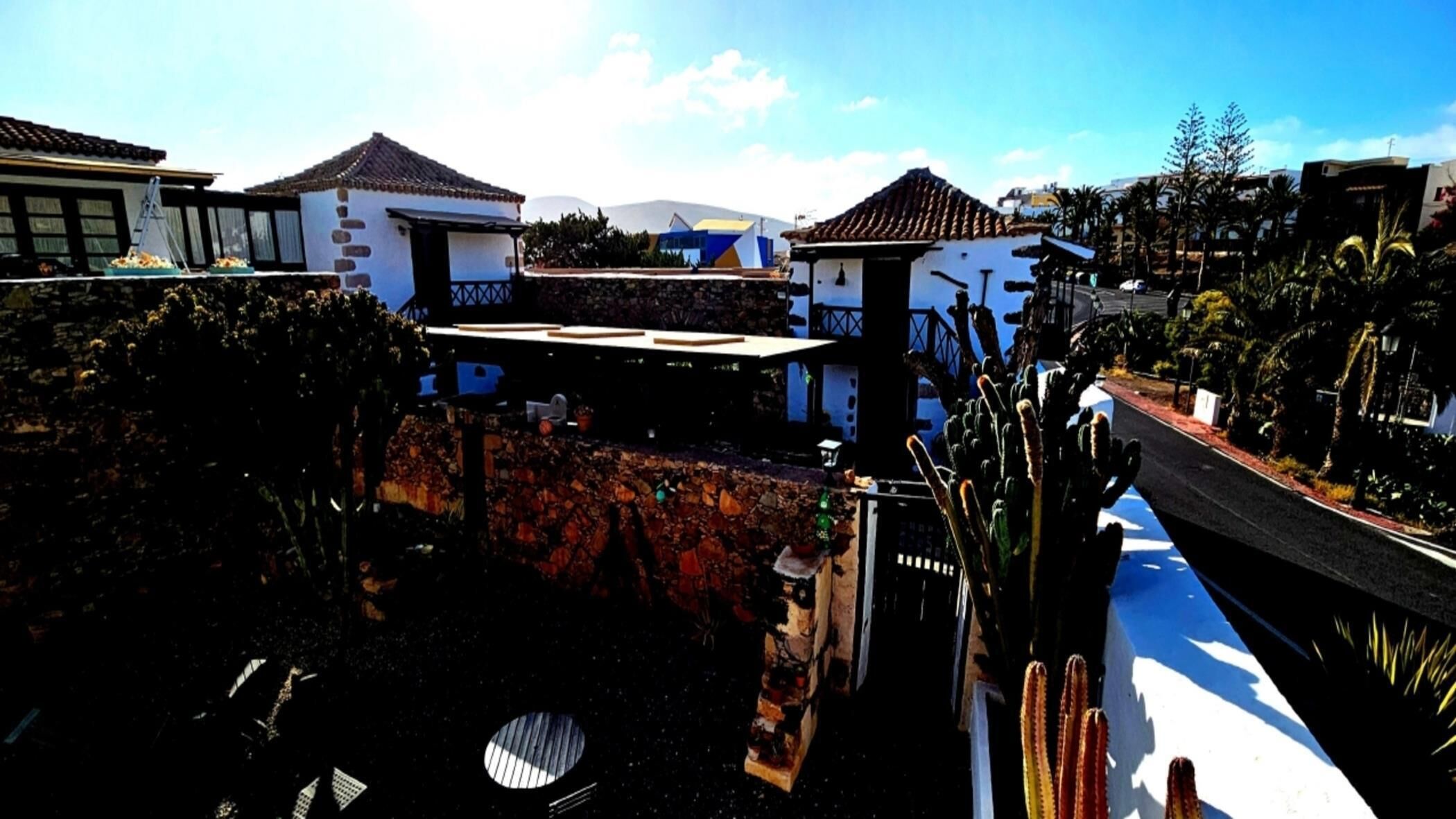 A residential area with houses, a street, and a clear sky.