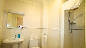 Een badkamer met een wastafel, toilet en douche.