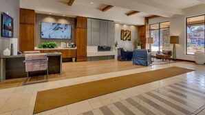 A modern lobby with a reception desk, seating area, and large windows. - Luxury @Heavenly Village, with Pool+Hot Tub+Games (South Lake Tahoe)