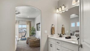A modern bathroom with a large mirror, white cabinets, and a vanity. - Luxury 5BR Wellness Retreat w/ Private Pool, Hot Tub & Cold Plunge Near Zion (Hurricane)