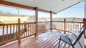 A wooden deck with a railing, a ceiling fan, and a view of a yard with a fence and trees. - 4 Mi to Lake Logan: Hocking Hills Apartment (Logan)