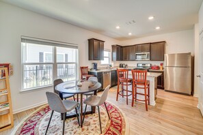 Enjoy meals in the kitchen with an oven, refrigerator, and microwave, and dine at the round table with four chairs.
