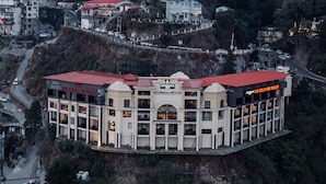 A hotel with a red roof, multiple balconies, and a sign reading "The Solitaire Resort". - The Solitaire Resort by Lawrence Hotels (Mussoorie)