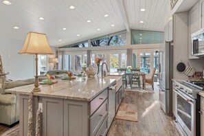 Enjoy cooking in this well-equipped kitchen with a large island and modern appliances.