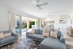 TV, fireplace, books, offices - 20 Taine - Oceanstays - Pet-Friendly Waterfront Escape with Fireplace (Yamba)