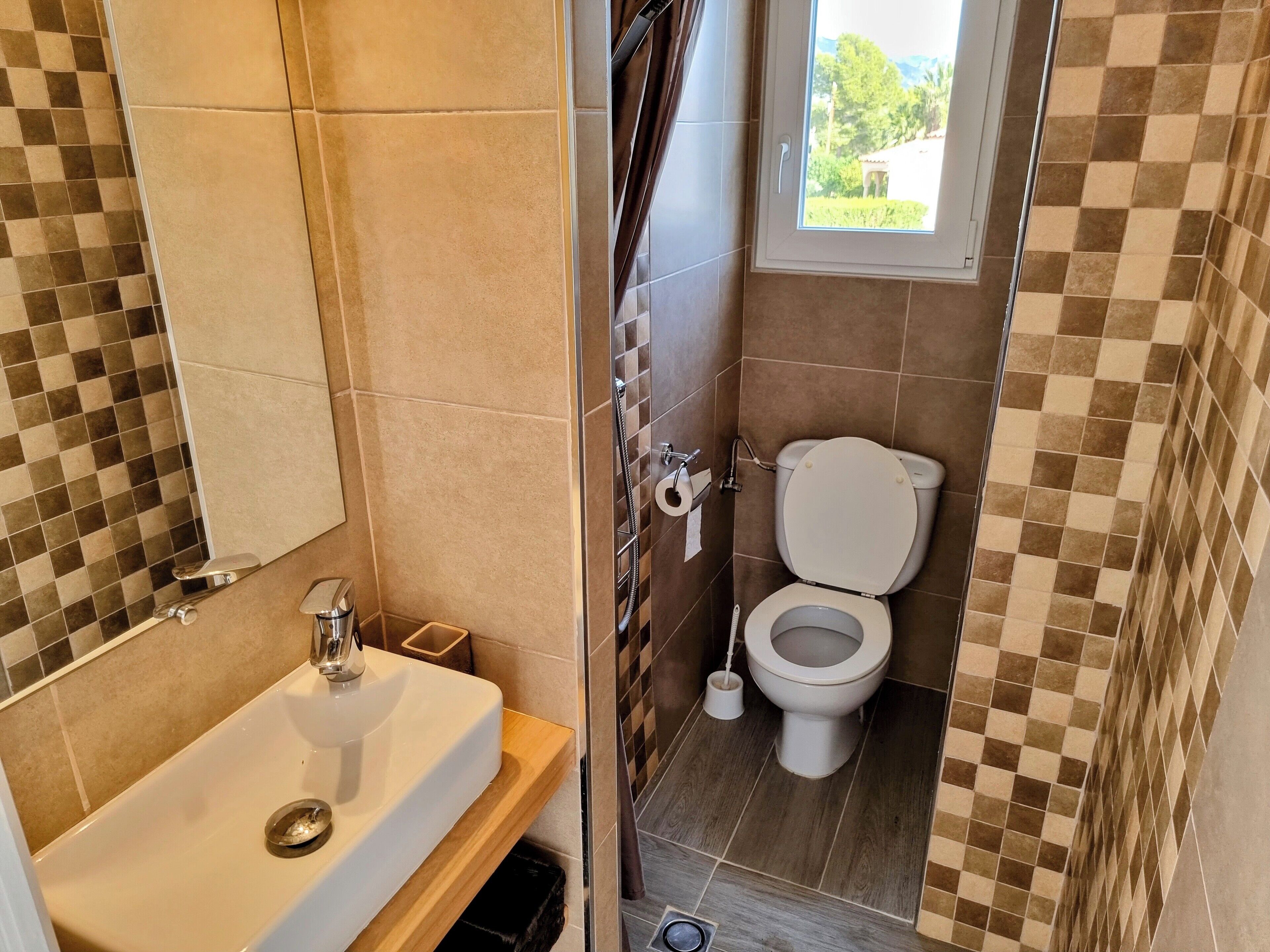 Kylpyhuone, jossa on pesuallas, wc ja suihku.