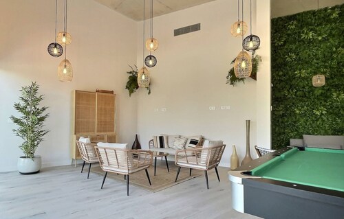 Experience luxury in this stunning three-bedroom modern townhouse frontline to the San Roque Golf