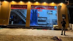 Hotel Sharda Palace with a modern facade, a staircase leading to the entrance, and a welcome sign in both English and Hindi. - Hotel Sharda Palace (Vrindavan)