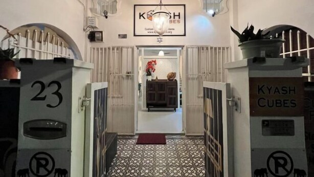 A hotel entrance with a sign reading "KYASH CUBES" and a number "23" on the wall. - Georgetown Kyash House 23 (Northeast Penang Island)