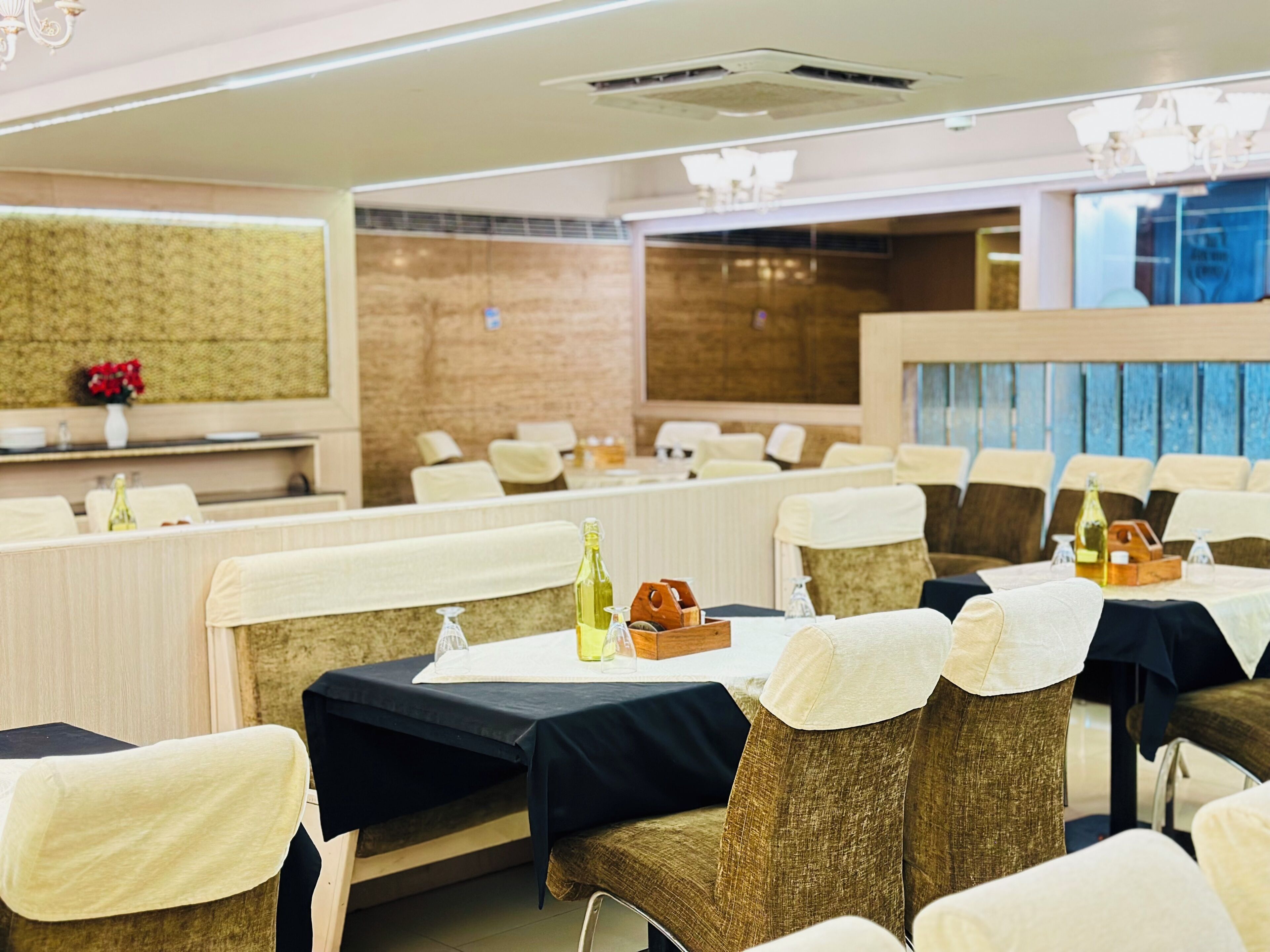 A hotel dining area with booths, tables, and chairs.