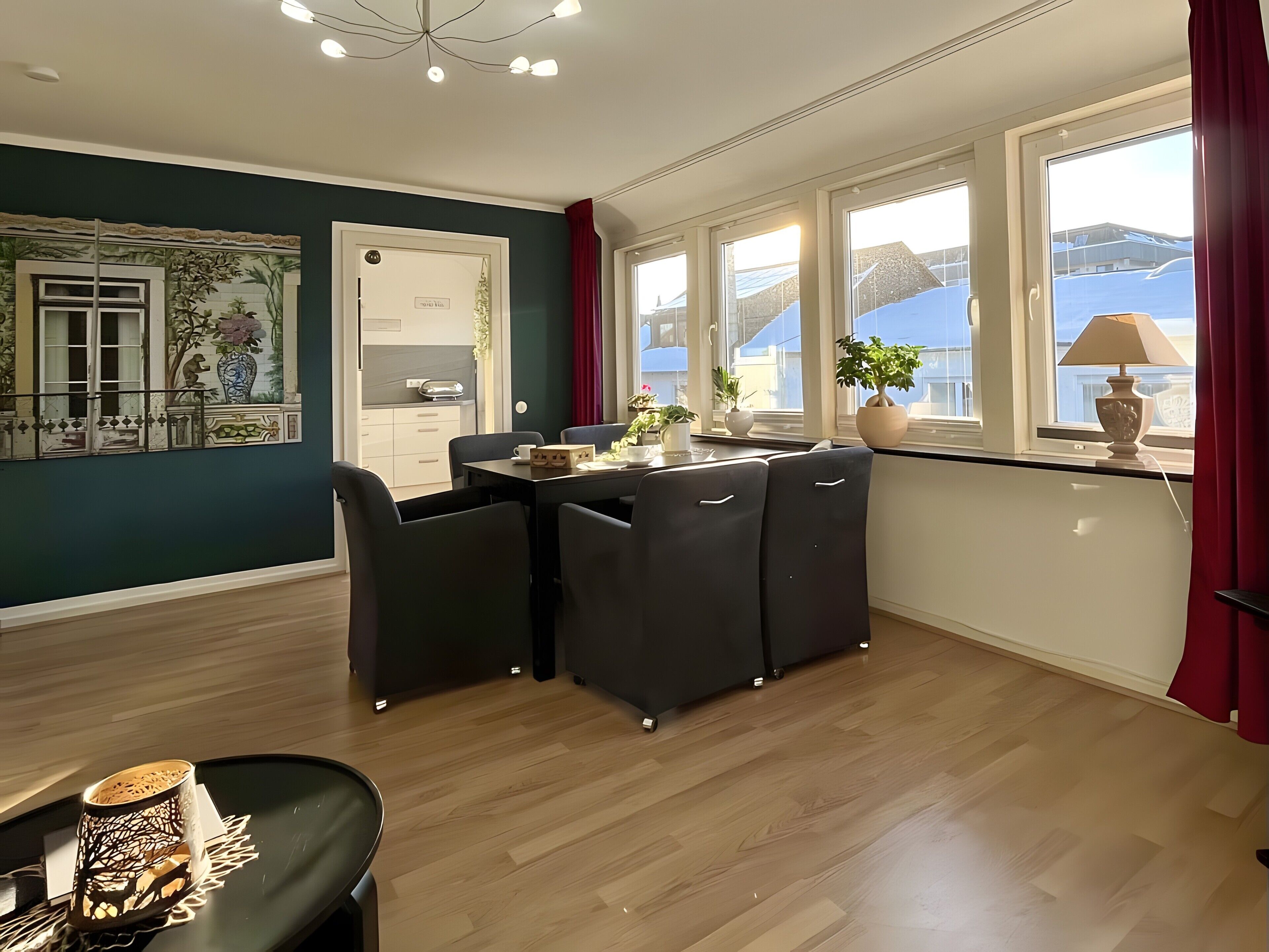 A modern dining area with a table, chairs, and a view of the outside.