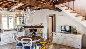 A spacious kitchen with a dining area, stone walls, wooden beams, and a chandelier. - Villa with private pool, hot tub. Quiet area & 100% privacy. panoramic views! (Umbria)