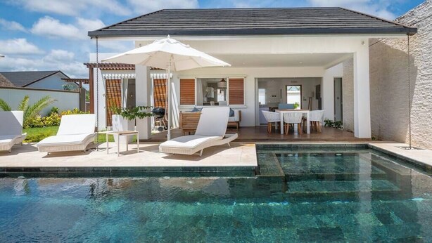 A modern outdoor pool area with lounge chairs and a covered seating area. - Villa BIJOU, 3 bed, grand bay center by Immoclair (Rivière du Rempart District)