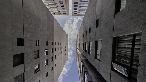 A corridor between two high-rise buildings with a clear sky above. - Staroot Residences- Celestial Chalet (Nairobi)